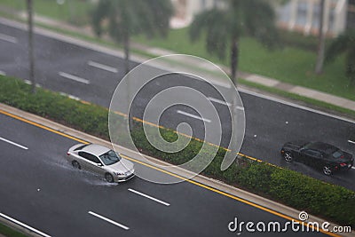 Sedan car driving in the rain