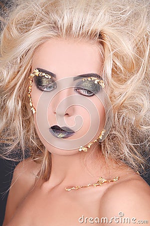 Seductive woman with shaggy hair and creative makeup