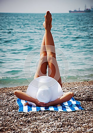 Seductive woman taking sunbathe on beach. Vintage.