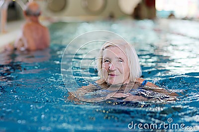 Senior active lady swims in the pool