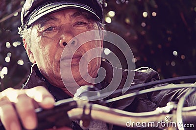 Senior asian man riding his bicycle