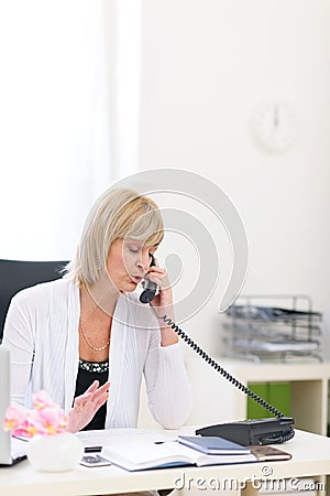 Senior business woman speaking phone