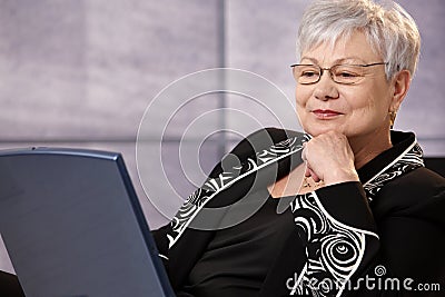 Senior businesswoman looking at computer screen