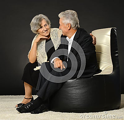 Senior couple on black background