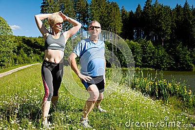 Senior couple doing sport exercising outdoors