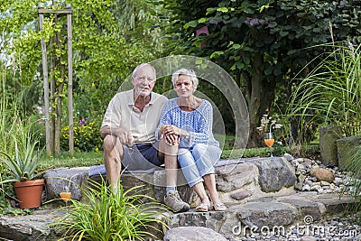 Senior couple enjoying summer in garden