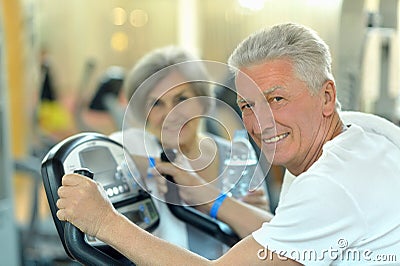 Senior Couple Exercising In gym