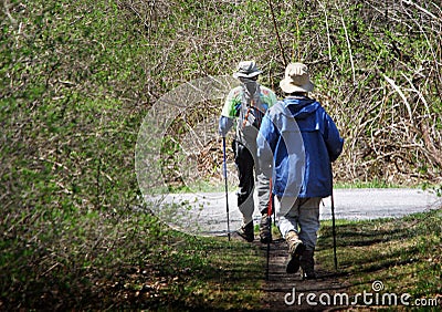 Senior Couple Hiking with Walking Sticks