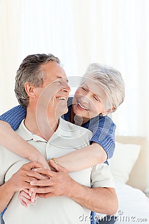 http://thumbs.dreamstime.com/x/senior-couple-hugging-their-bed-18109431.jpg