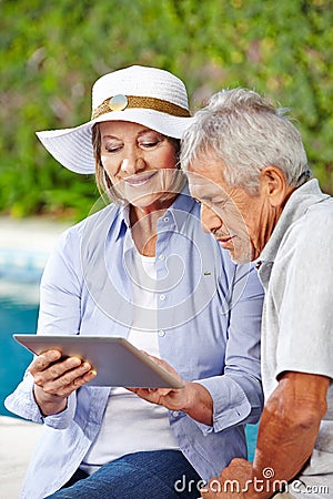 Senior couple looking at tablet computer