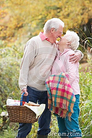 Senior Couple Outdoors With Picnic Basket