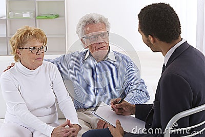 Senior couple receiving financial planner