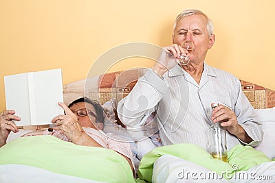 Senior couple relaxing in bed