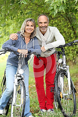 Senior couple relaxing after riding bicycle