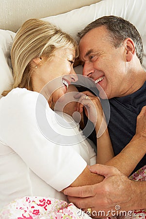 Senior Couple Relaxing Together In Bed