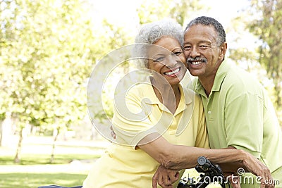 Senior Couple Riding Bikes In Park