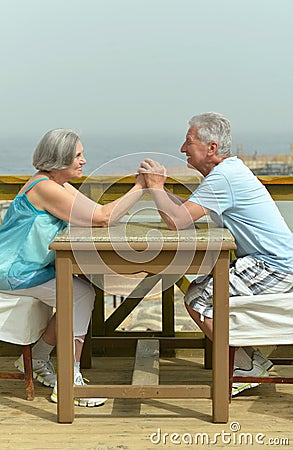 Senior couple at table at beach