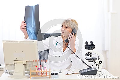 Senior doctor woman speaking phone
