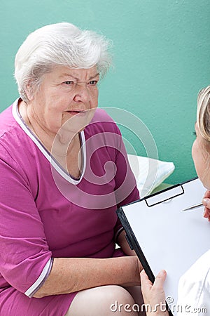 Senior with female doctor and clipboard