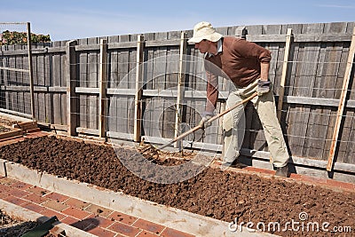 Senior gardening with garden fork