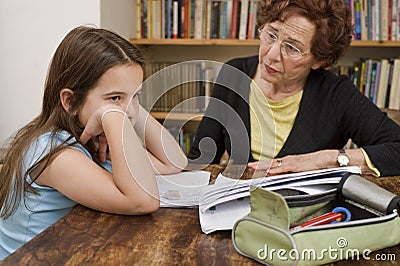 Senior halping child doing homework