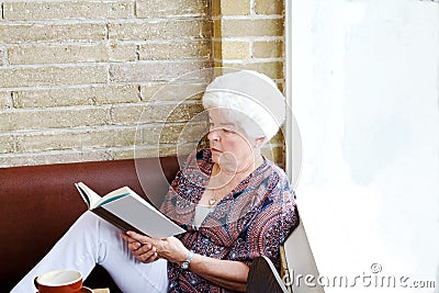 Senior lady reading in coffee shop