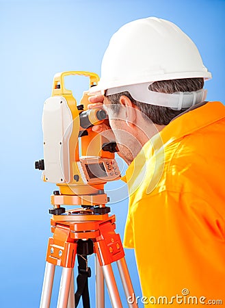 Senior land surveyor with theodolite