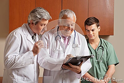 Senior Male Doctor With Colleagues