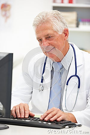 Senior male doctor at desk