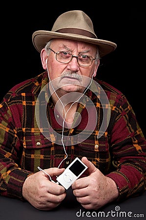 Senior male listening to mp3 music player