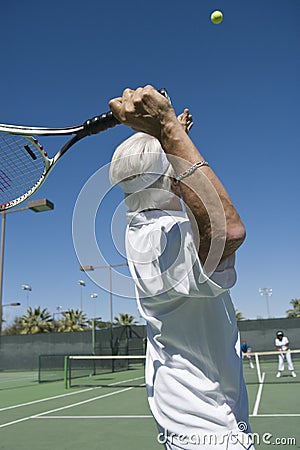 Senior Male Tennis Player Serving