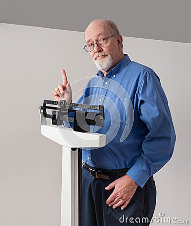 Senior Male on Weight Scale Holding Up One Finger