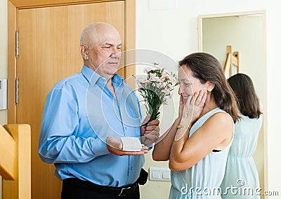 Senior man came to woman with present