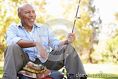 Senior Man On Camping Holiday With Fishing Rod