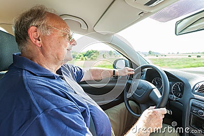 Senior man driving a car