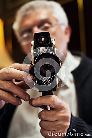 Senior man holding video Camera