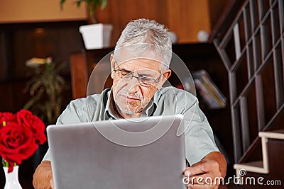 Senior man in hotel with tablet computer