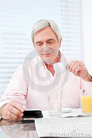 Senior man looking at smartphone