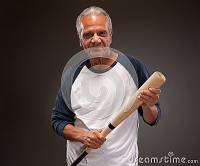 Senior man posing with baseball bat