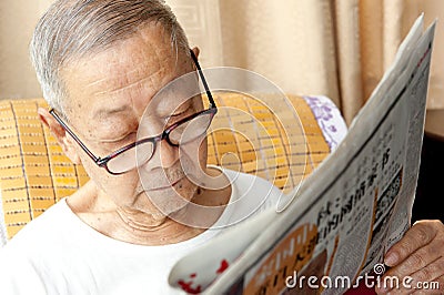 A senior man is reading