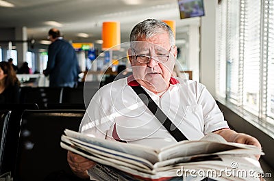 Senior man reading newspaper