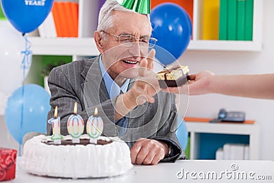 Senior man receiving birthday gift