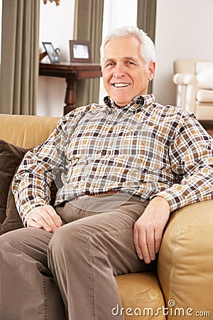 Senior Man Relaxing In Chair At Home