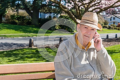 Senior Man Talking on Cell Phone in Park