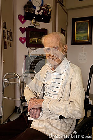 Senior Man Sitting in Wheel Chair in Care Facility