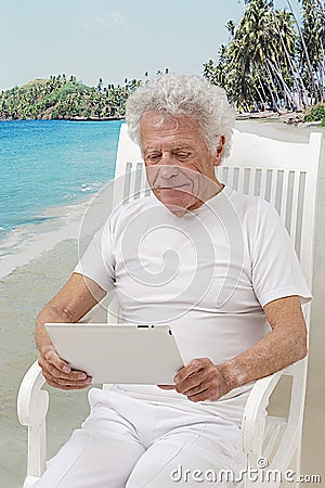 Senior man with tablet on holidays