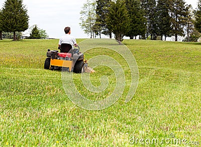 Senior man on zero turn lawn mower on turf