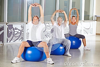 Senior people stretching in gym