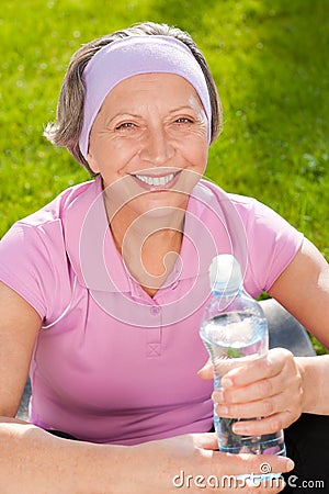 Senior sportive woman smile hold bottle water