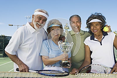 Senior Tennis Players Holding Trophy
